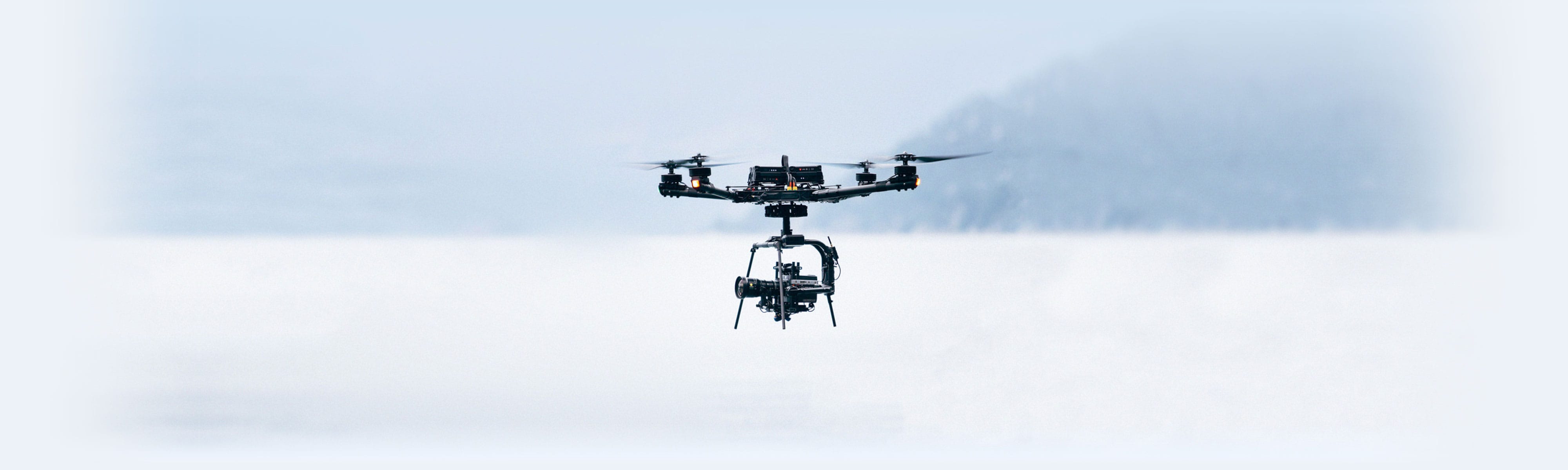 Alta X carrying a cinema camera during a flight over a snowy field