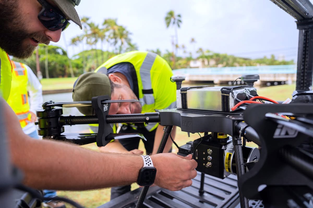 Technicians preparing UAV LiDAR equipment at a Consor field site in Hawaii